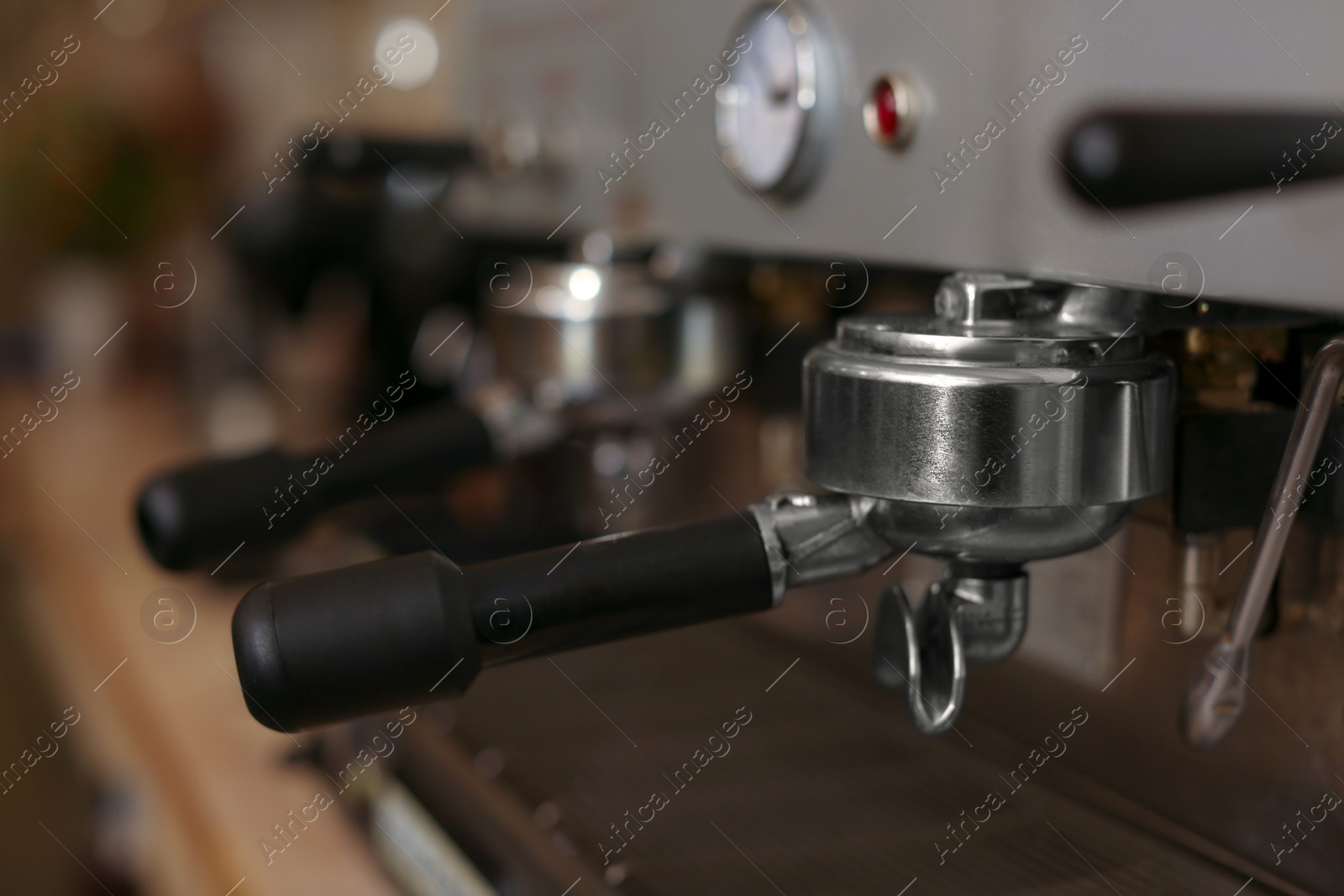 Photo of Modern electric coffee machine with portafilter, closeup