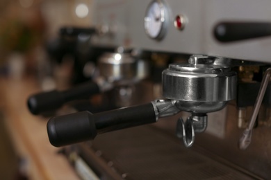 Modern electric coffee machine with portafilter, closeup