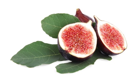 Photo of Fresh juicy purple figs and green leaves on white background