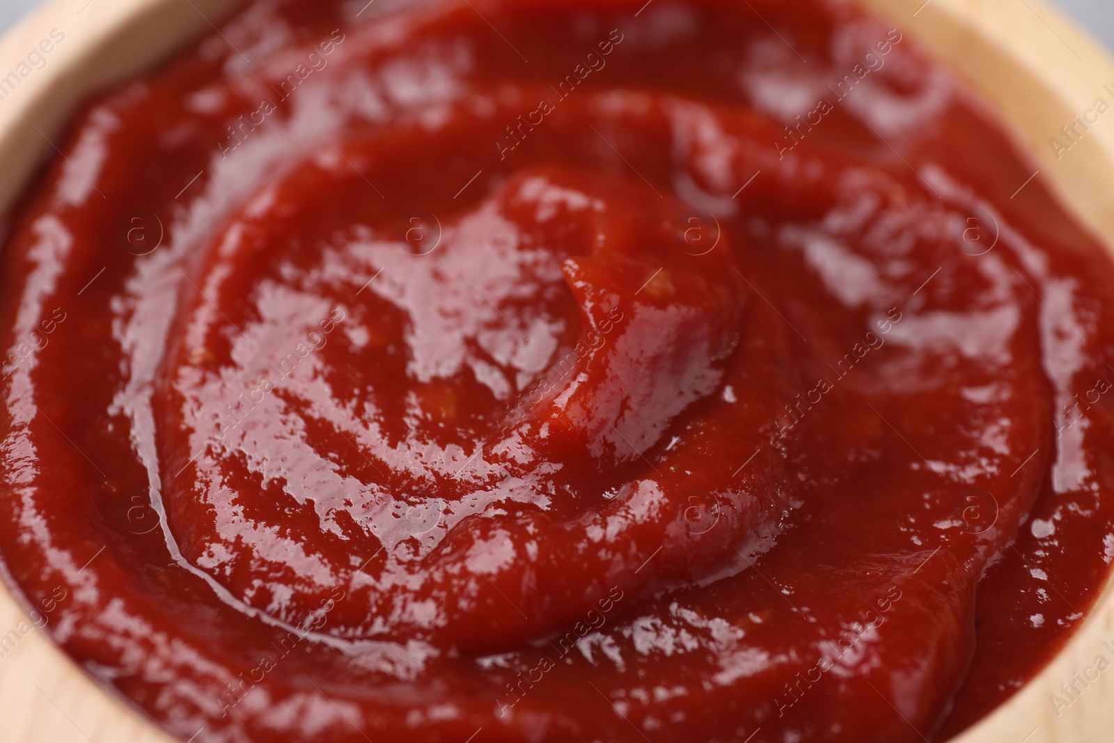 Photo of Organic ketchup in bowl, closeup. Tomato sauce