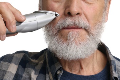 Photo of Man trimming beard on white background, closeup