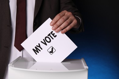 Man putting paper with text My Vote and tick into ballot box on dark blue background