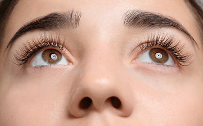 Photo of Young woman with beautiful eyelashes, closeup view