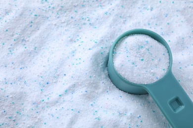 Measuring spoon with laundry powder, above view with space for text