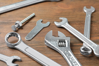 Photo of Auto mechanic's tools on wooden background, closeup