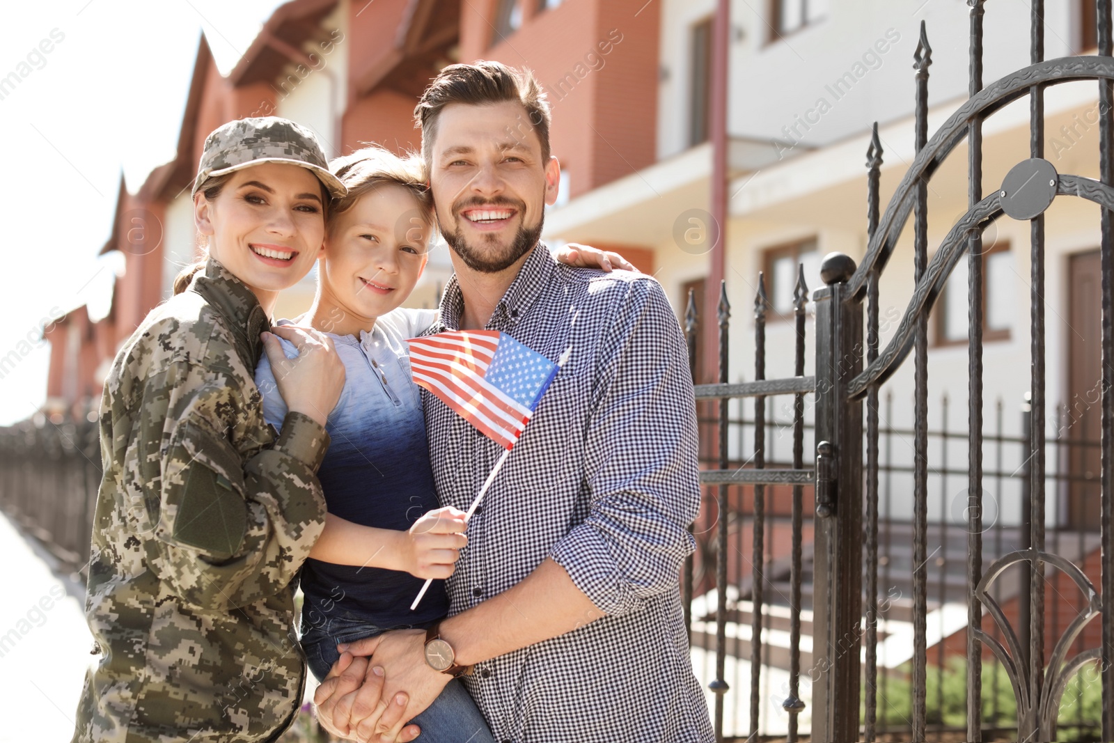 Photo of Female soldier with her family outdoors. Military service