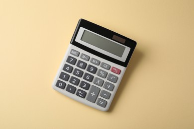 Photo of Calculator on beige background, top view. Office equipment