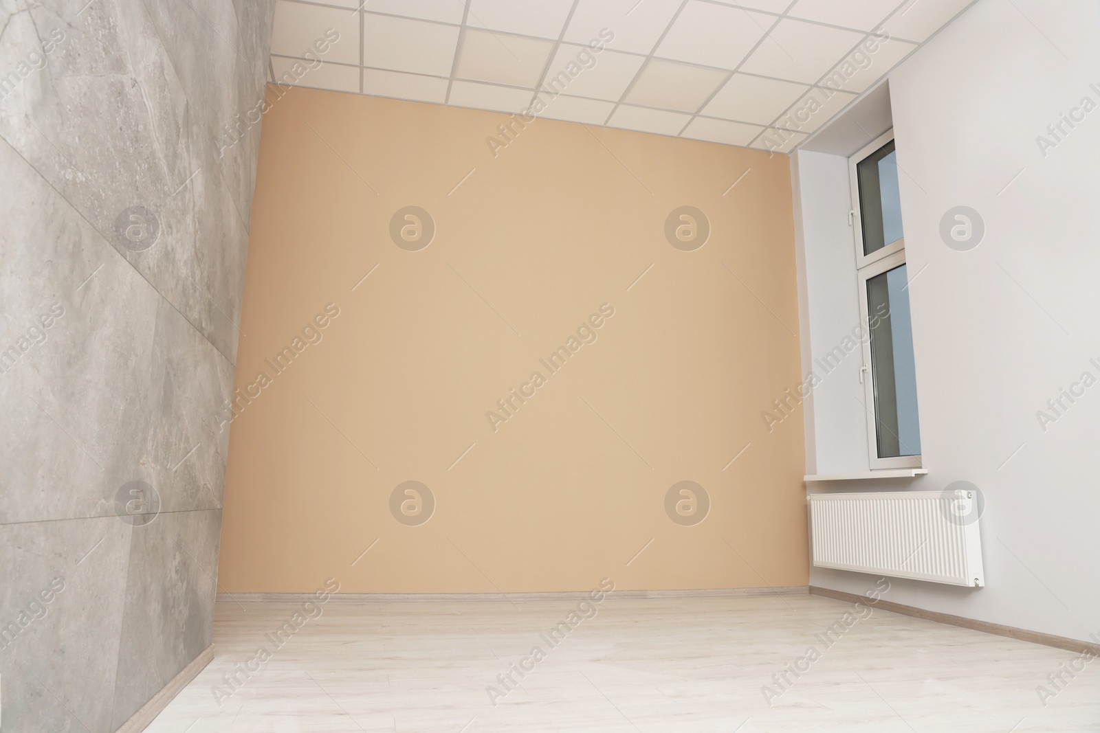 Photo of New empty office room with clean window and beige wall