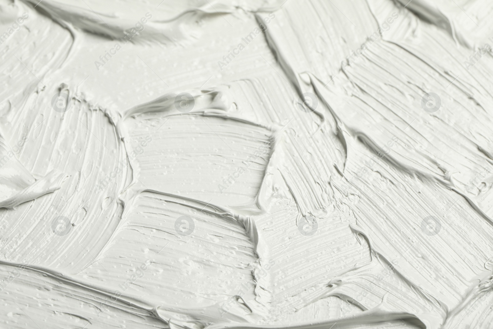 Photo of Texture of white oil paint as background, closeup