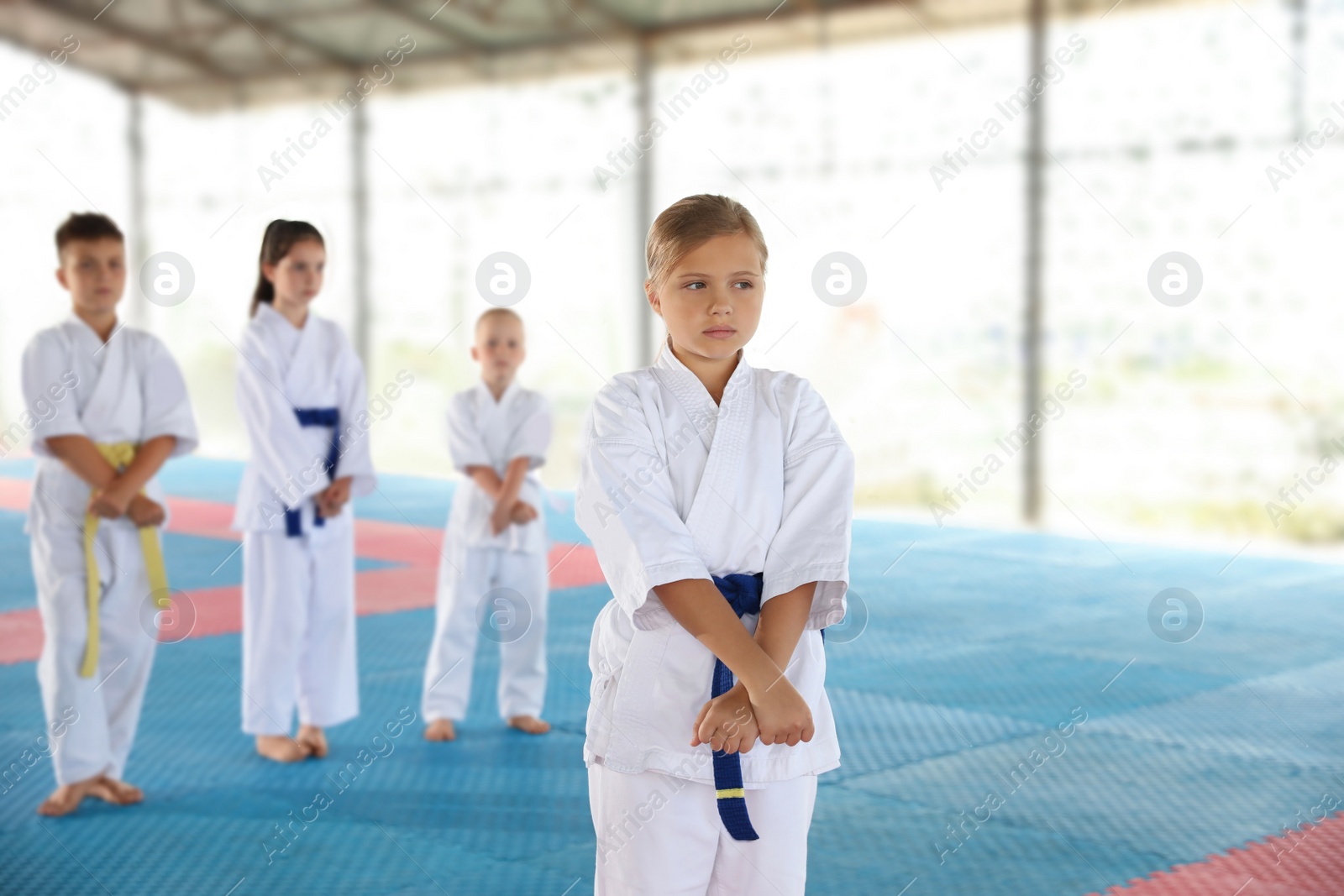 Photo of Girl in kimono during karate practice on tatami outdoors