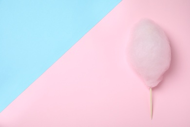 Sweet pink cotton candy on color background, top view. Space for text