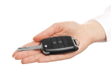 Woman holding car key isolated on white