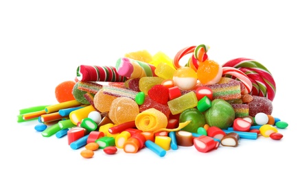 Photo of Many different yummy candies on white background