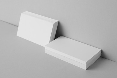 Blank business cards on light gray background. Mockup for design