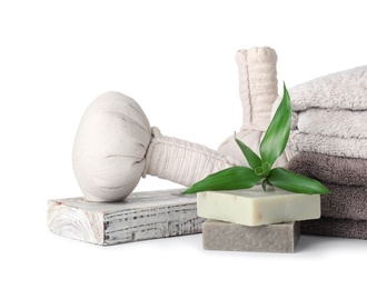 Composition with towels, soap and herbal bags on white background. Spa treatment