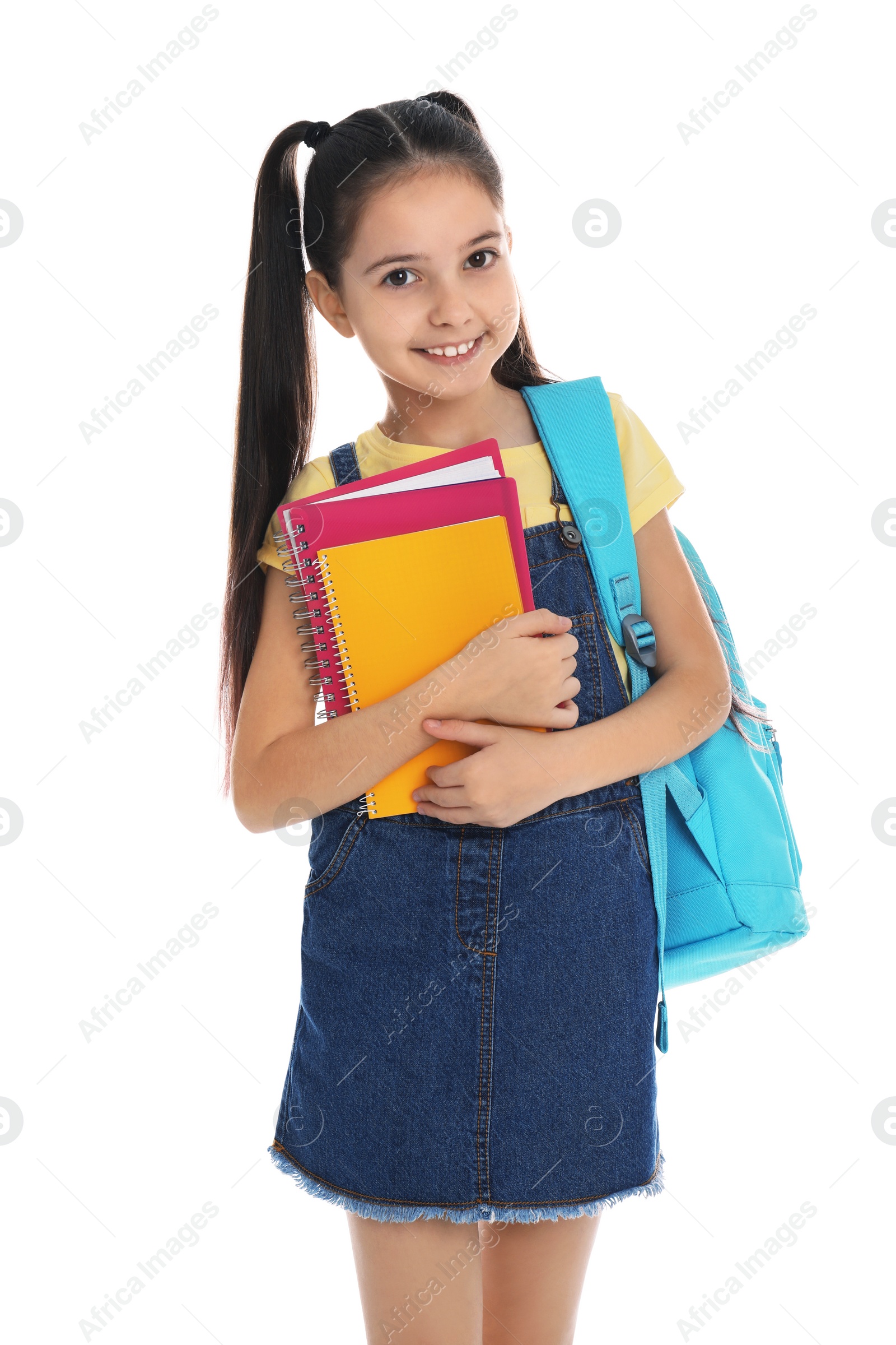 Photo of Little girl with school stationery on white background