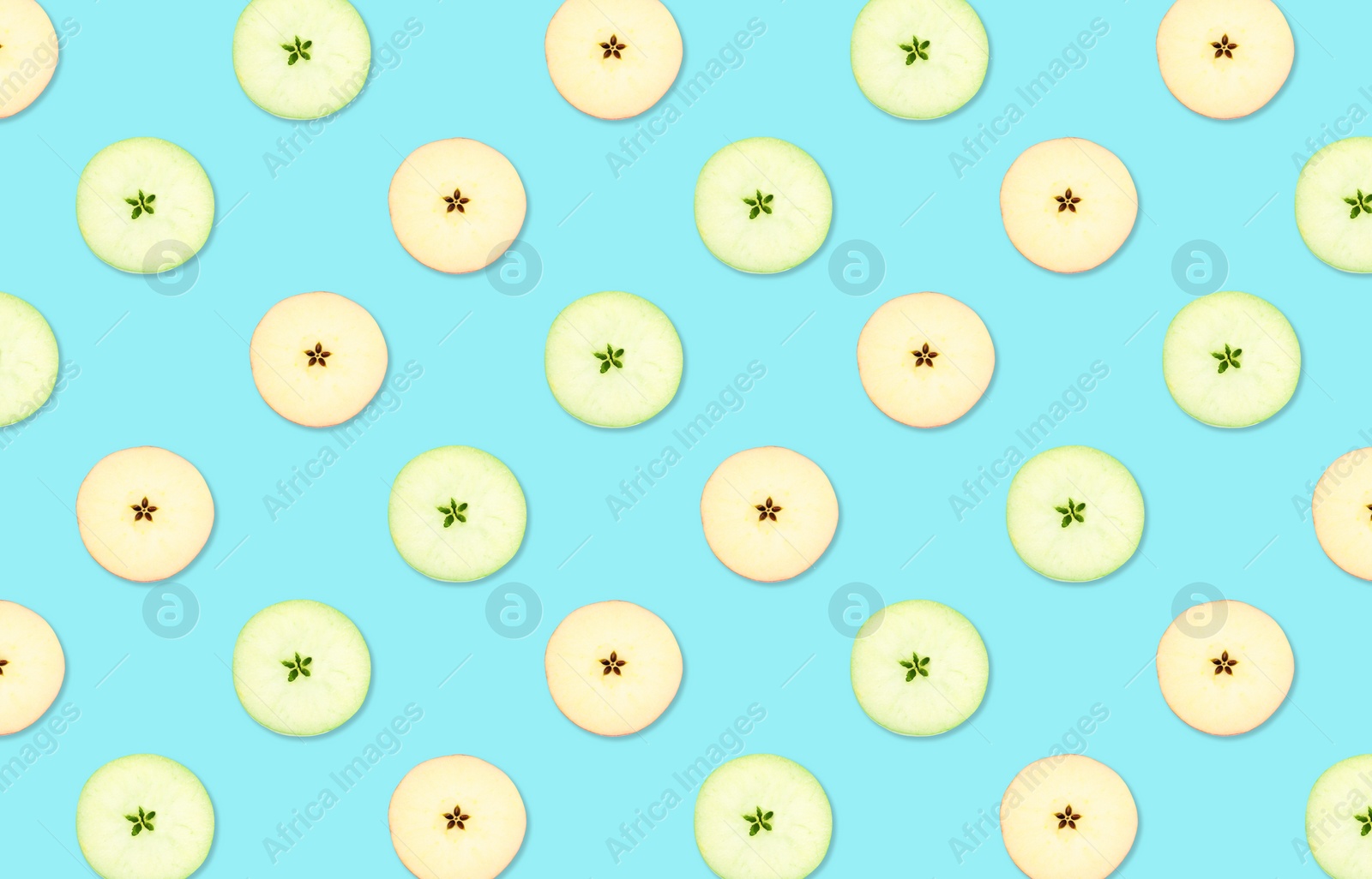 Image of Pattern of red and green apple slices on light blue background
