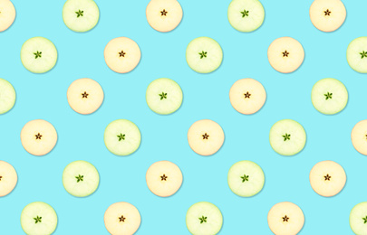 Image of Pattern of red and green apple slices on light blue background