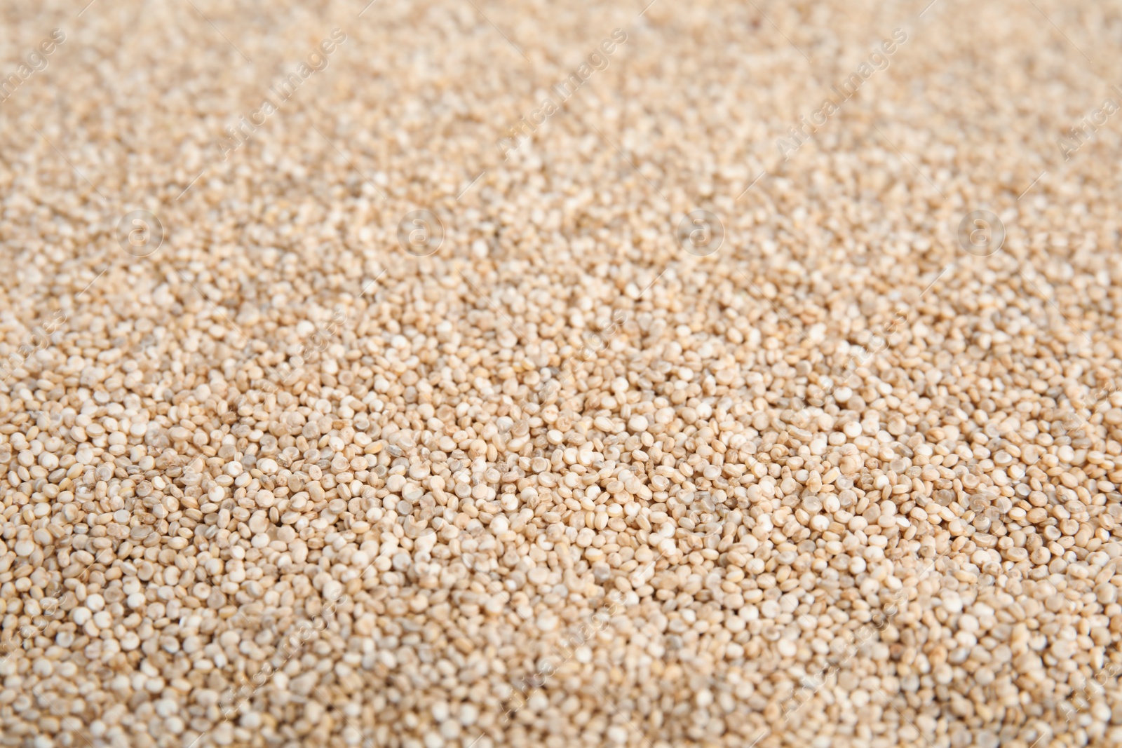 Photo of Pile of uncooked white quinoa as background, closeup