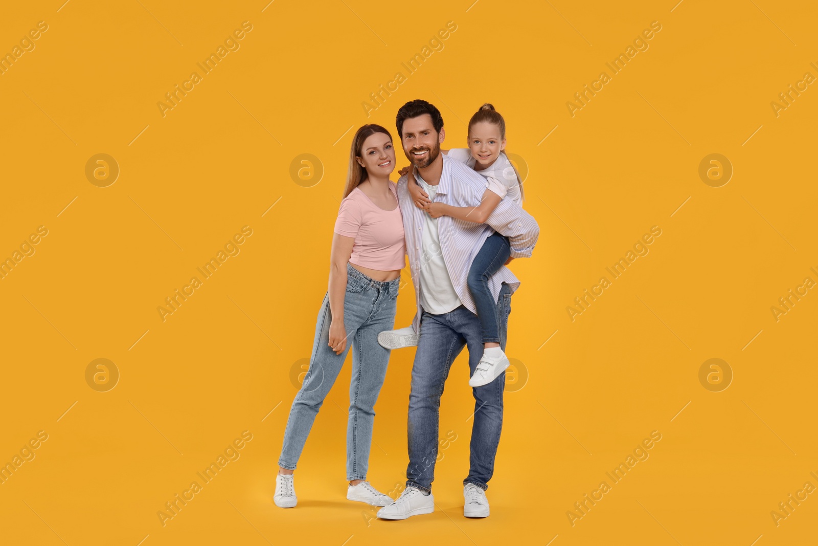 Photo of Portrait of happy family on orange background