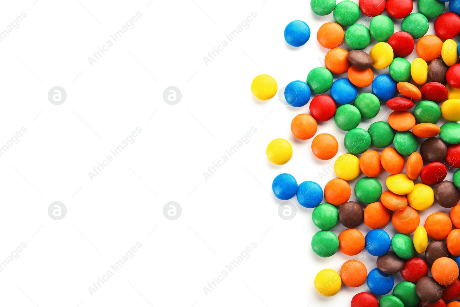 Photo of Tasty colorful candies on white background, top view