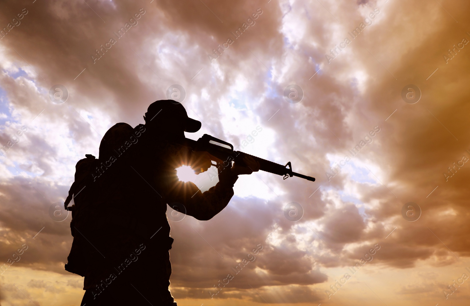 Photo of Soldier with machine gun patrolling outdoors. Military service