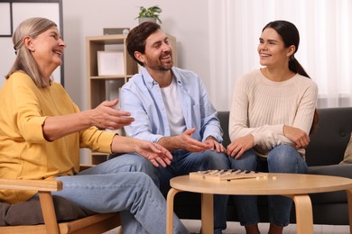 Family talking while playing checkers at home