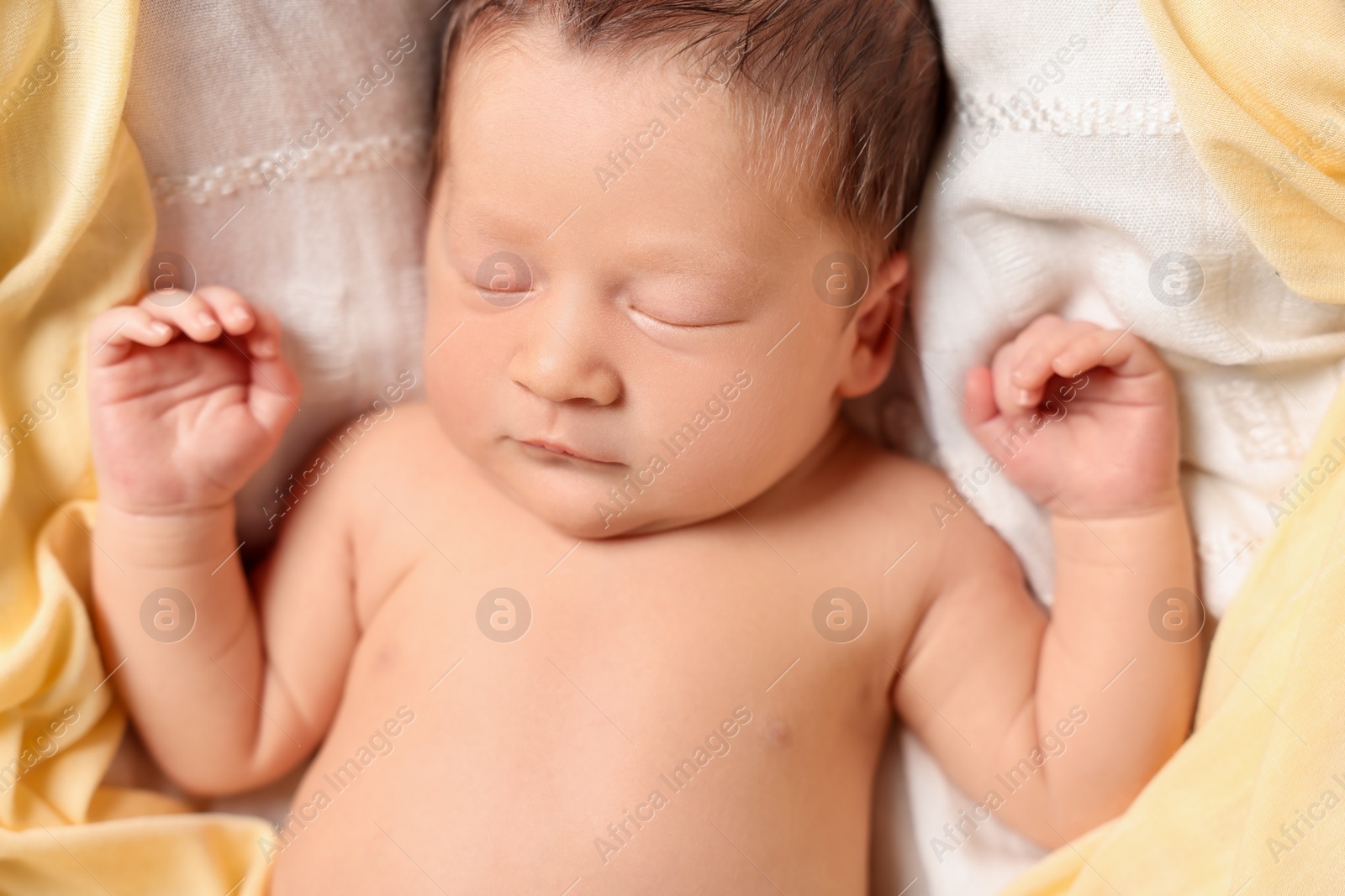 Photo of Cute newborn baby sleeping on white blanket, top view