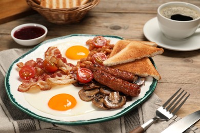 Photo of Traditional English breakfast served on wooden table, closeup