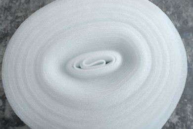 Photo of Polyethylene foam roll on gray background, above view