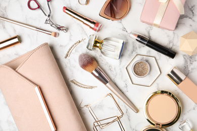 Photo of Flat lay composition with different luxury makeup products and accessories on white marble table