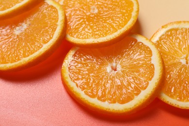 Photo of Slices of juicy orange on color background, closeup