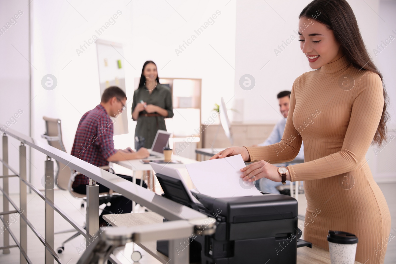 Photo of Employee using new modern printer in office