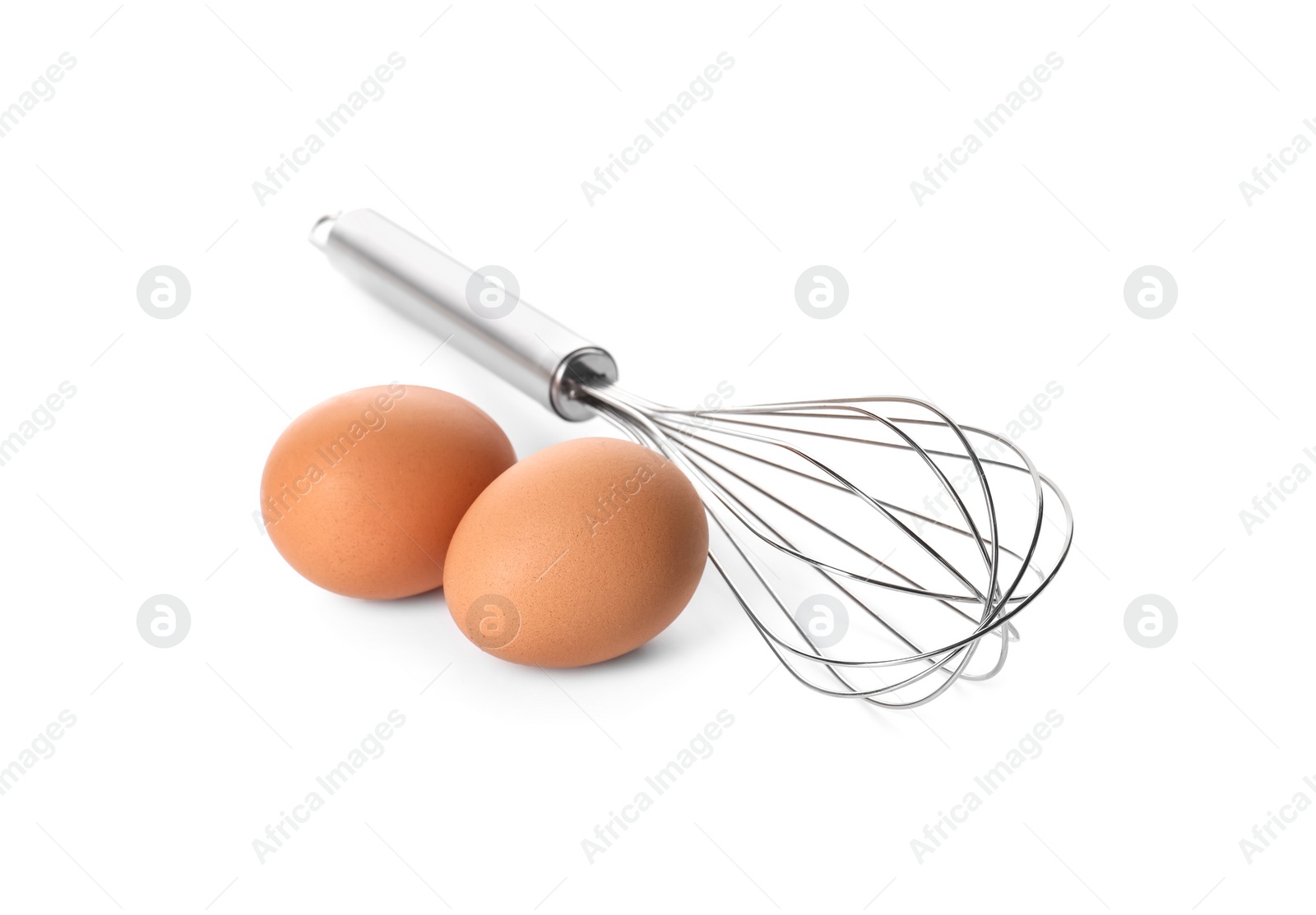 Photo of Metal whisk and raw eggs isolated on white