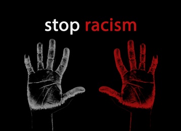 Stop Racism. Hand prints on dark background