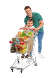 Father and son with full shopping cart on white background