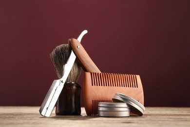 Moustache and beard styling tools on wooden table