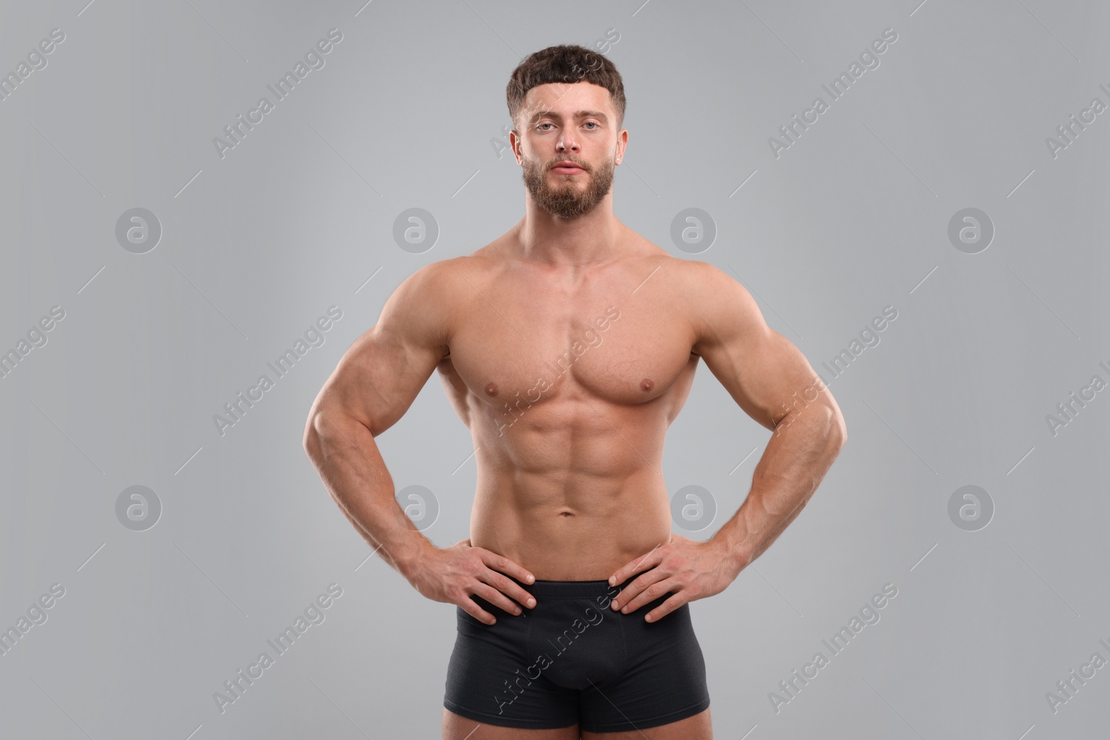 Photo of Handsome muscular man on light grey background. Sexy body