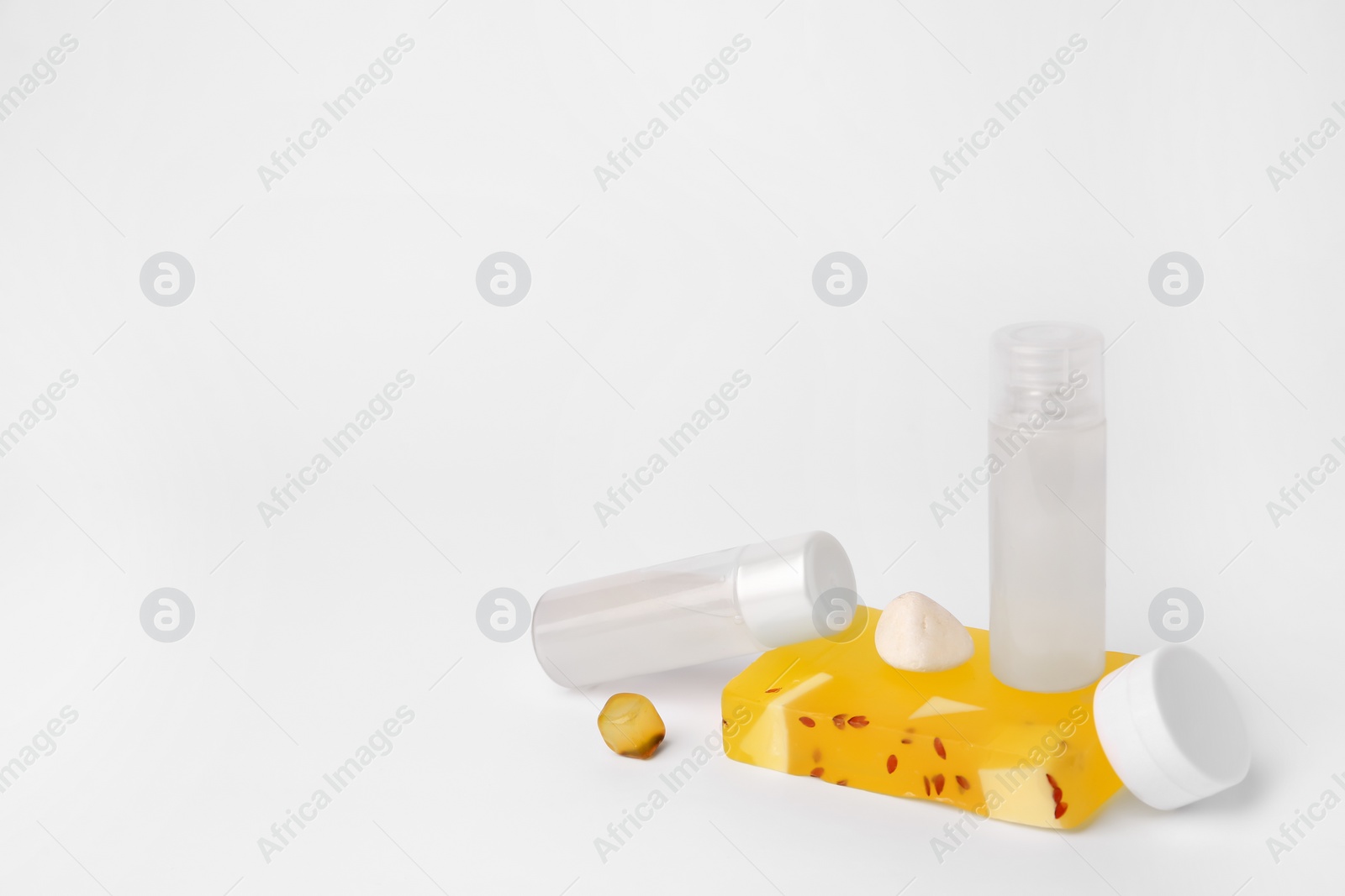 Photo of Different cosmetic products and stones on white background. Space for text