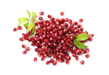 Photo of Pile of tasty pomegranate grains and leaves isolated on white