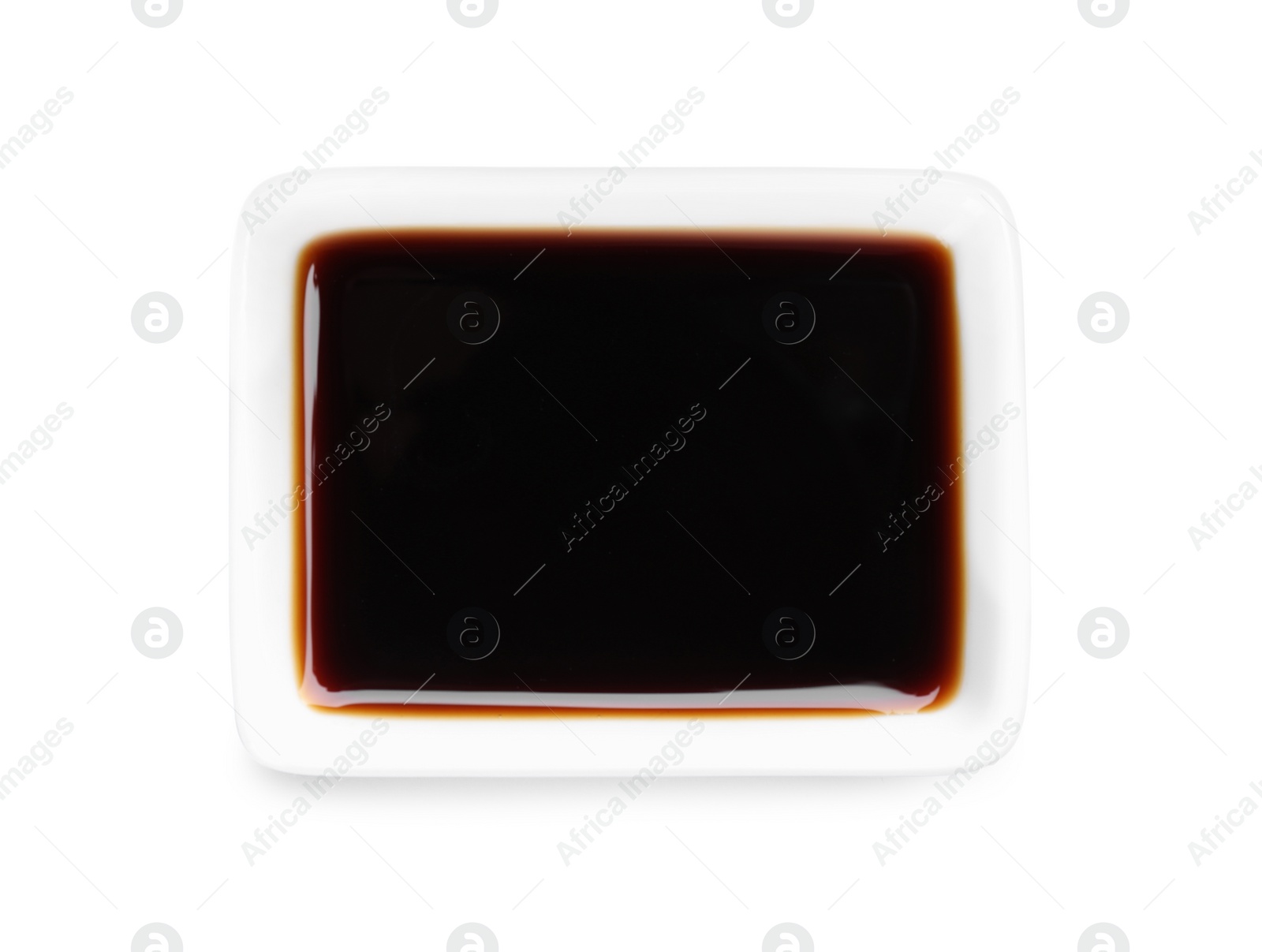 Photo of Bowl of tasty soy sauce isolated on white, top view