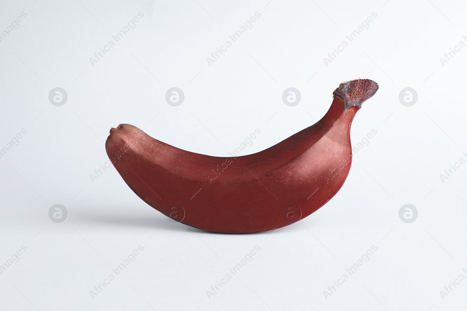 Photo of Tasty red baby banana on light blue background