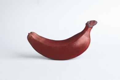 Photo of Tasty red baby banana on light blue background