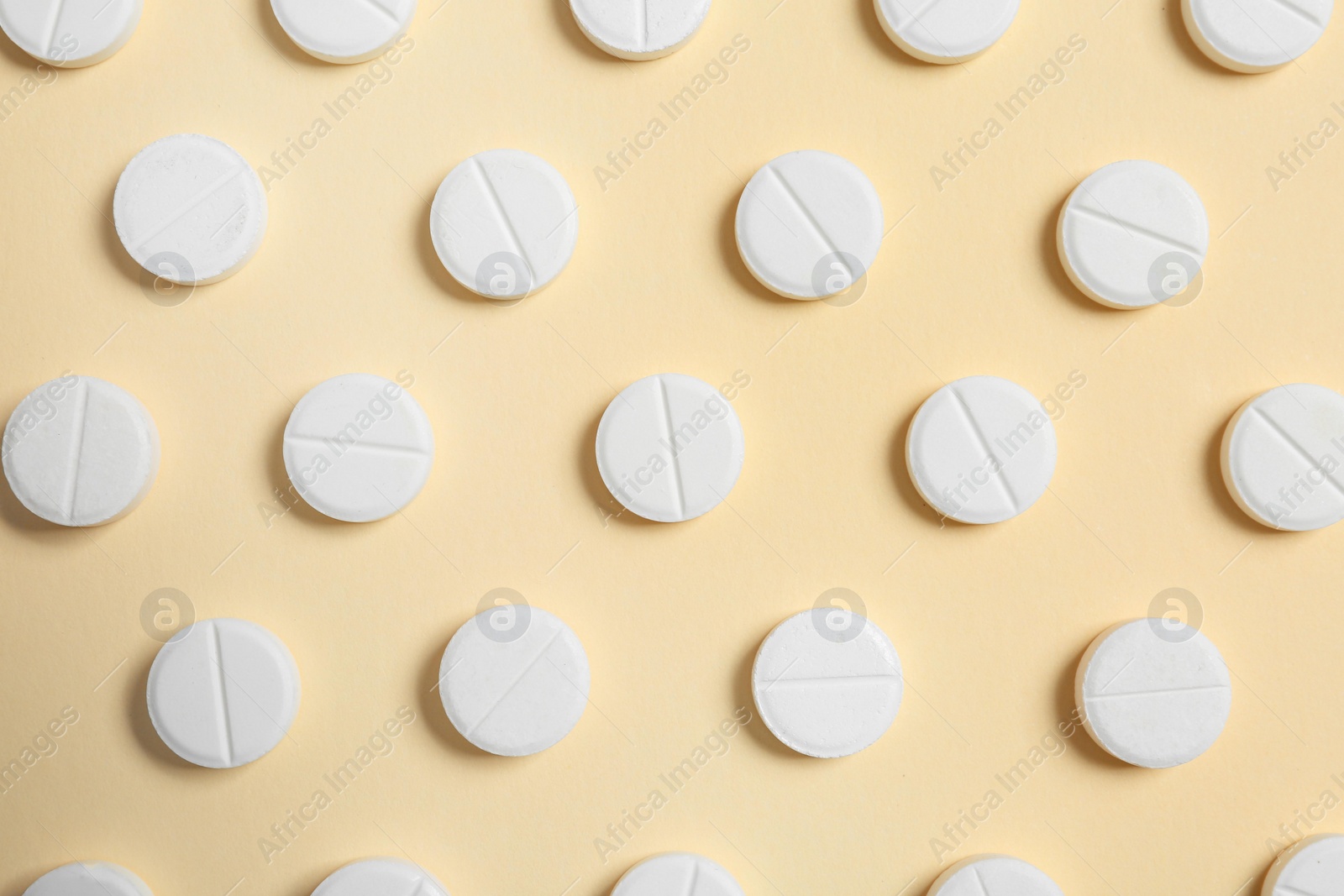 Photo of Flat lay composition with white pills on color background