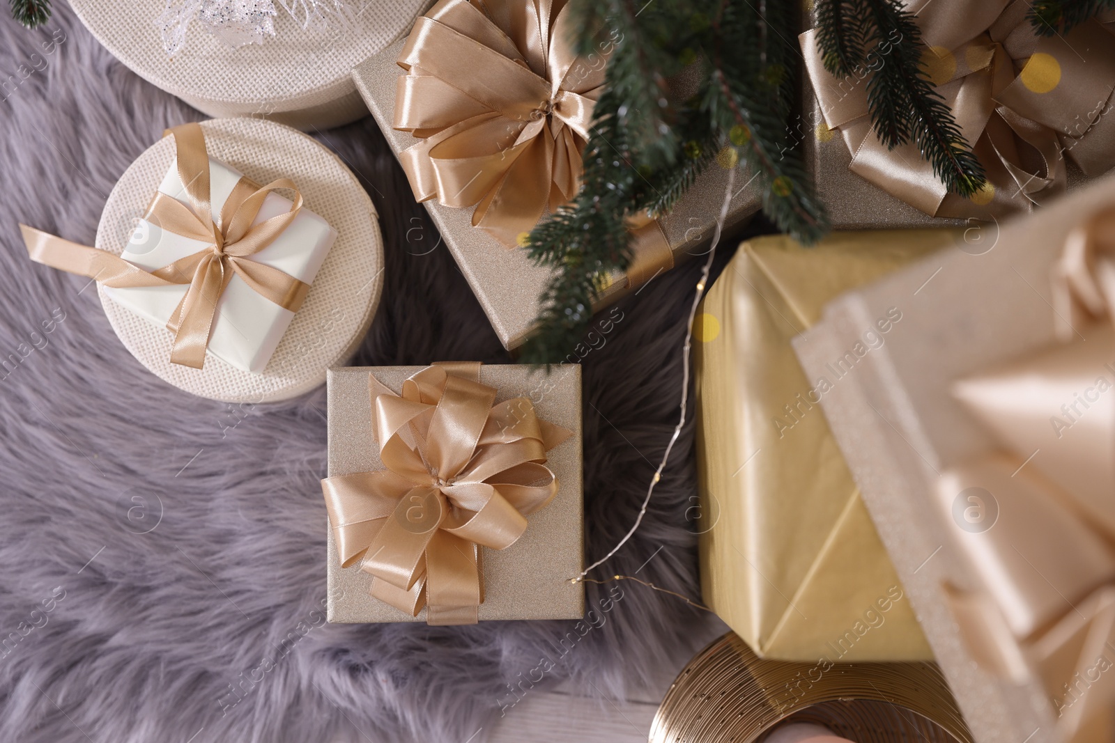 Photo of Christmas gift boxes on floor, flat lay