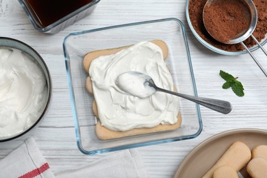 Flat lay composition with different ingredients for tiramisu cake on white wooden table