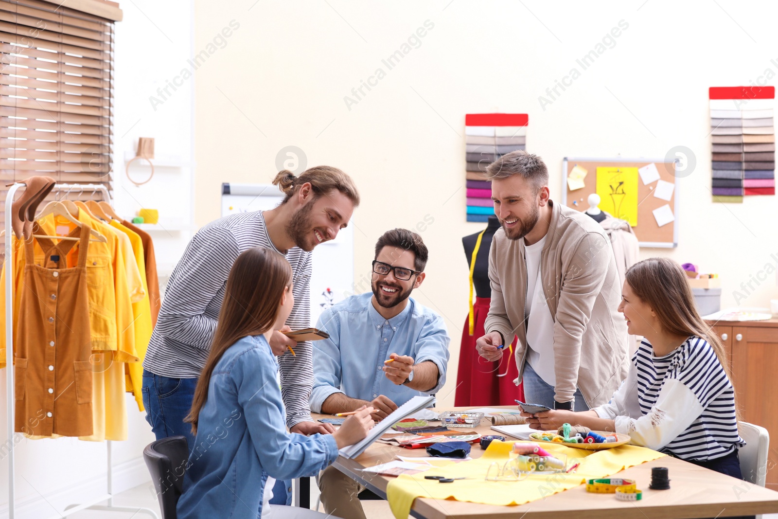 Photo of Fashion designers creating new clothes in studio