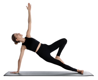 Photo of Young woman in sportswear practicing yoga on white background