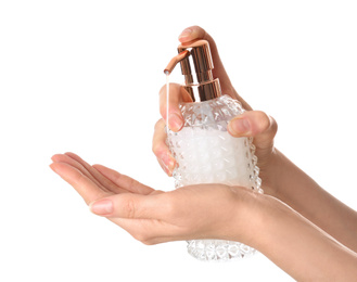 Woman holding soap dispenser on white background, closeup