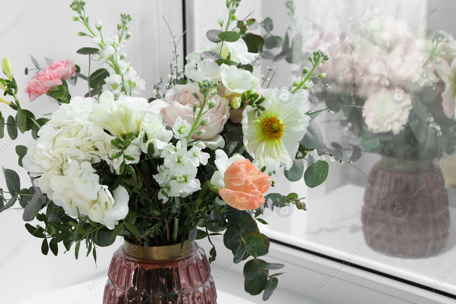Photo of Bouquet of beautiful flowers near window indoors